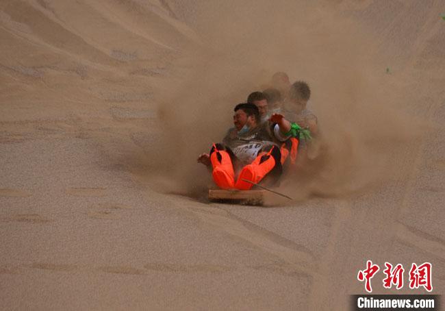 6月13日，敦煌鳴沙山月牙泉景區(qū)舉辦滑沙比賽。　馮豆 攝